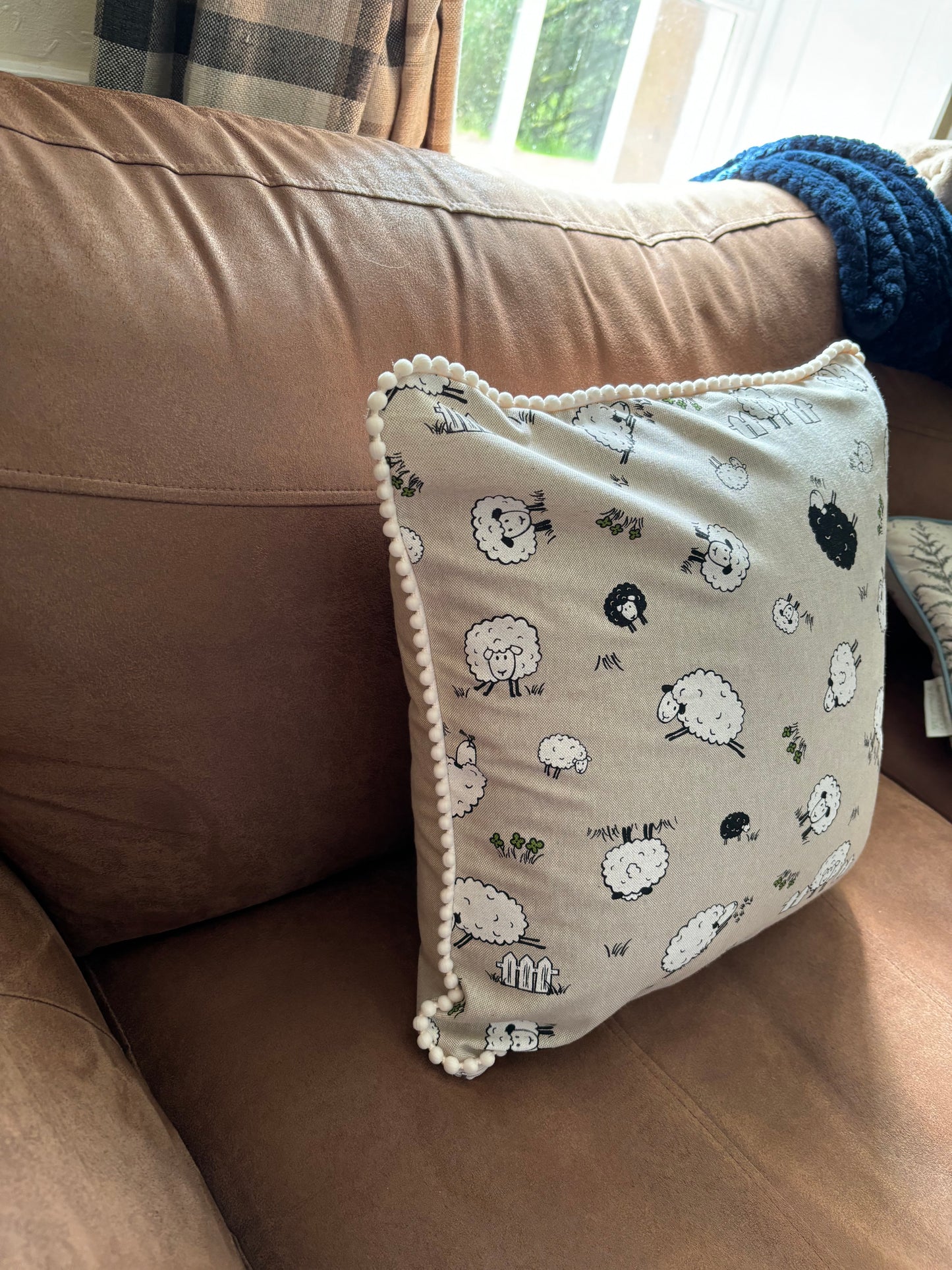 Sheep pom pom cushion