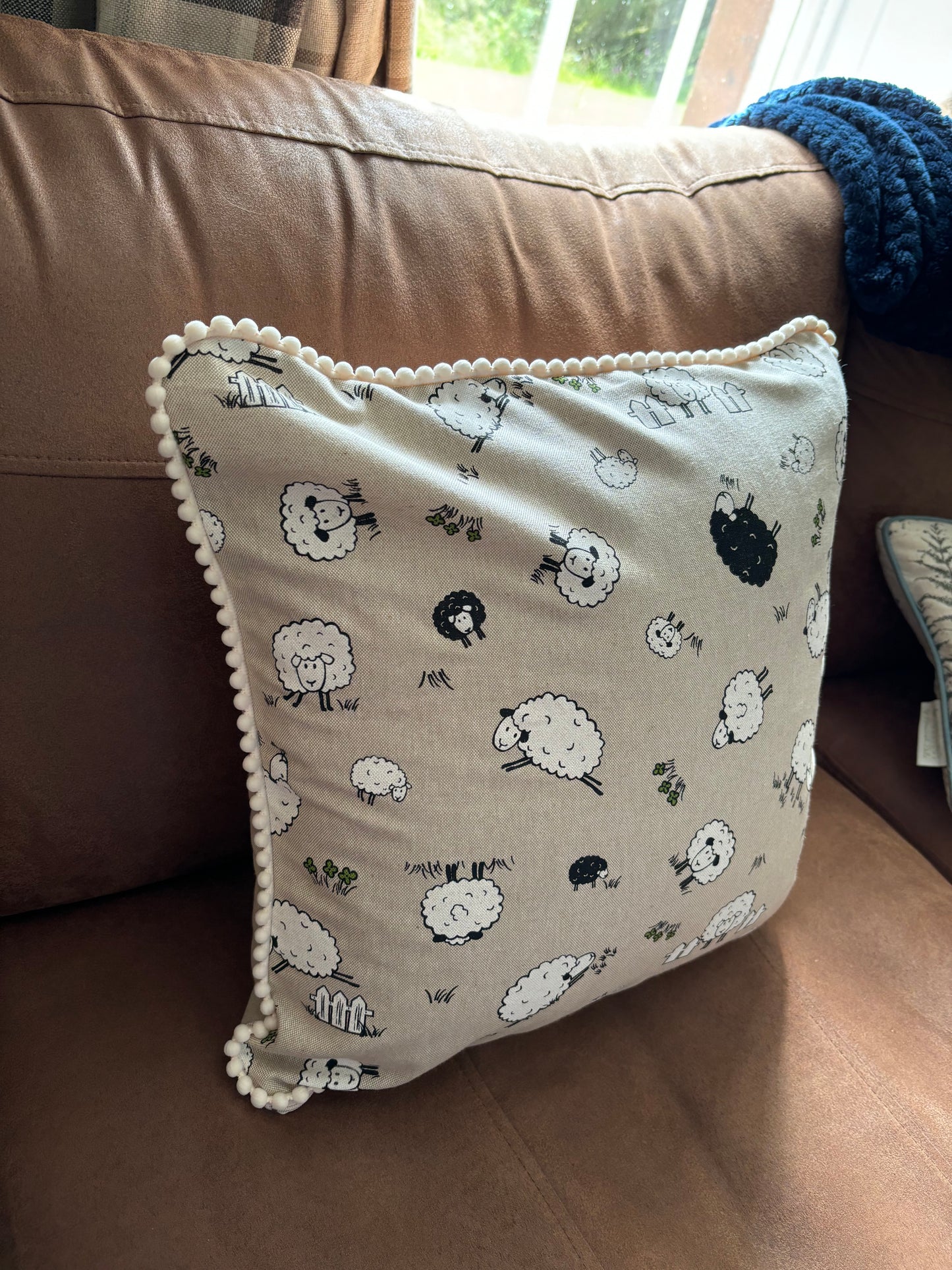 Sheep pom pom cushion